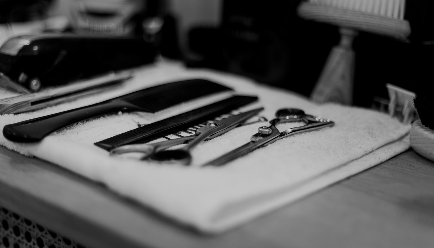 Combs and scissors laid out on a towel